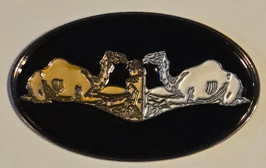 Decorative emblem with gold and silver figures on a black background