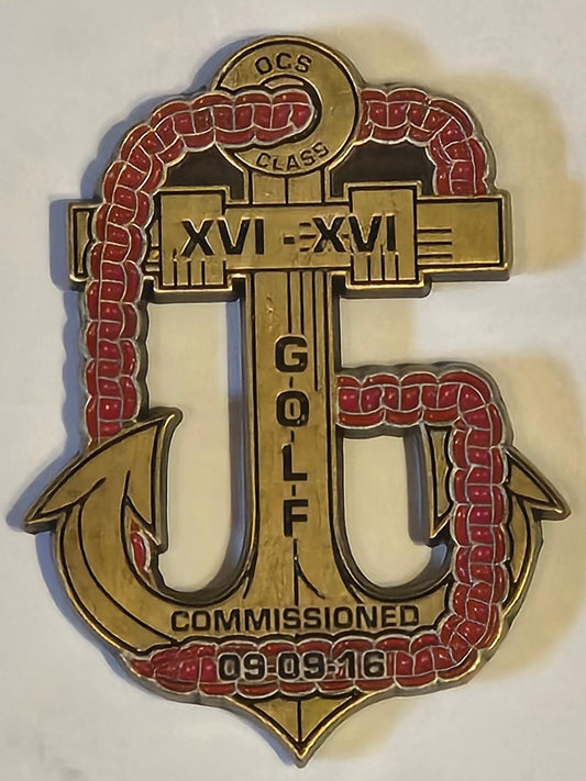 Decorative naval insignia with gold and red colors on a white background